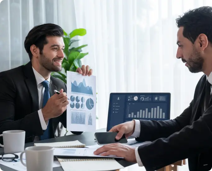 male-showing-graphs-to-another-male-using-computer male showing graphs to another male using computer