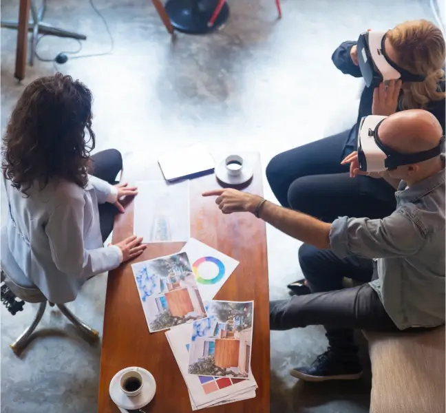 people gathered around tableu using virtual reality headsets