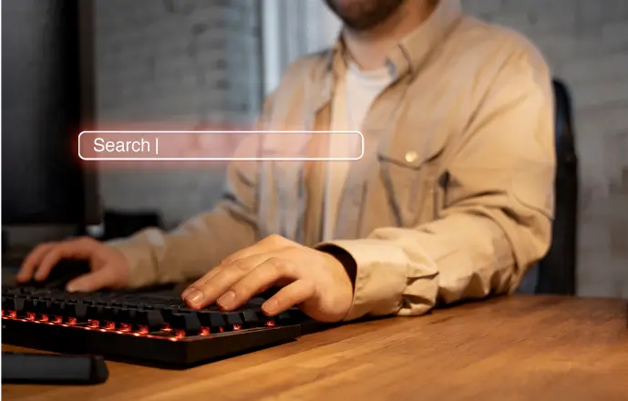 person typing on keyboard darker background