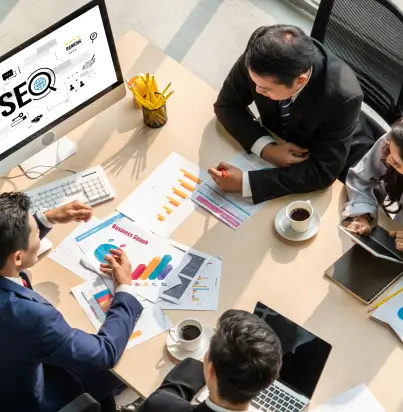 team-of-men-working-around-desk-and-computer-display-showing-seo team of men working around desk and computer display showing seo