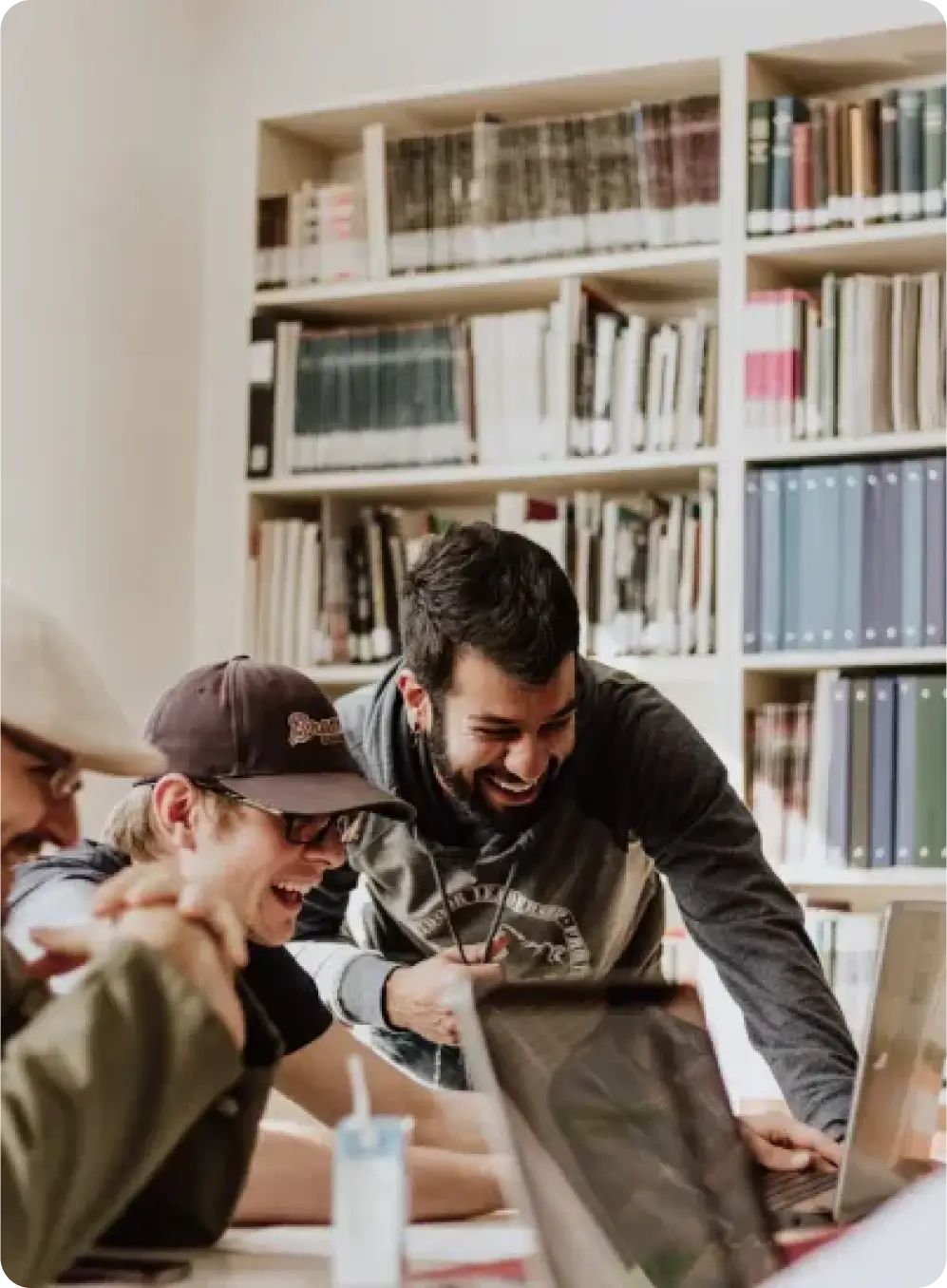 team-standing-behind-laptop-and-pointing-to-it team standing behind laptop and pointing to it