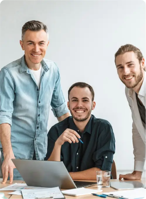 three-middle-aged-men-behind-computer-looking-in-this-direction three middle aged men behind computer looking in this direction